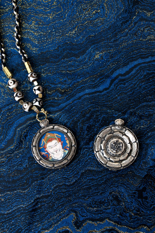 A portable Padmasambhava Thangka amulet designed to enhance communication, wisdom, and spiritual protection.
