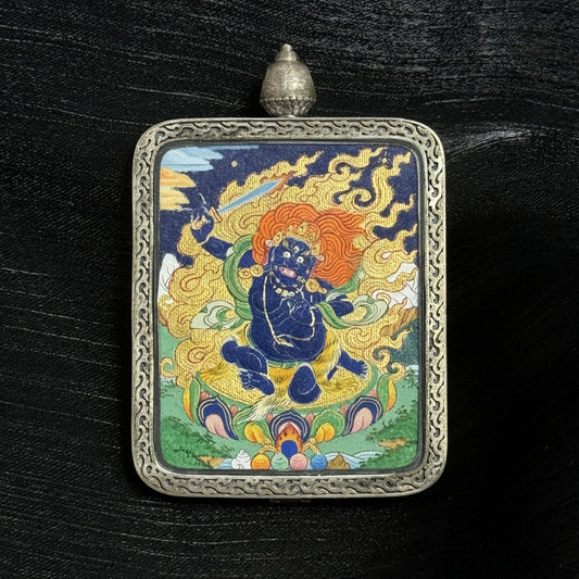 The Tibet Bold Acala Thangka pendant displayed as a sacred amulet for discipline and obstacle removal, embodying Tibetan Buddhist tradition.