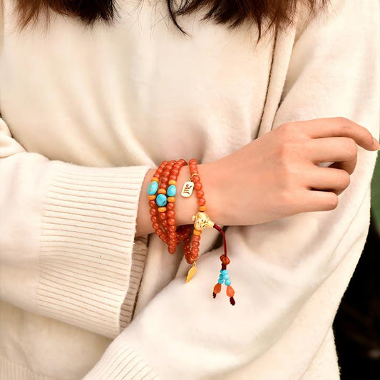 Tibetan Buddhist Jewelry Culture: A handmade natural Cherry Red Nan Hong Agate 108 mala beads necklace, showcasing sacred Buddhist jewelry art and vitality.