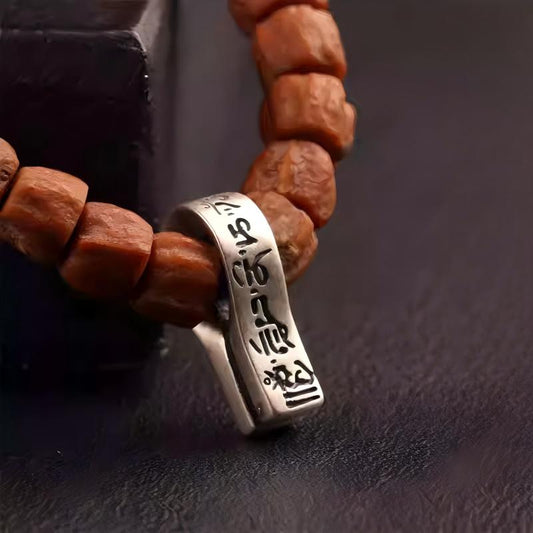 Handmade silver Six-Syllable Mantra clip on a mala, a sacred symbol of Tibetan Buddhist Jewelry Culture and jewelry art