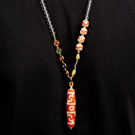 Tibetan Buddhist Jewelry Culture red meat agate pendant with Lotus Guru Rinpoche and ritual implements. A masterpiece of jewelry art. Source
