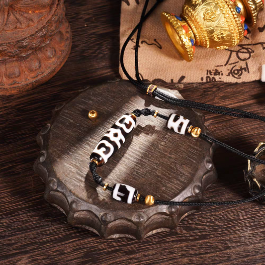 Tibetan Buddhist Jewelry Culture necklace featuring nine-eyed and three-eyed Dzi beads. A powerful piece of jewelry art for success and wealth. Source