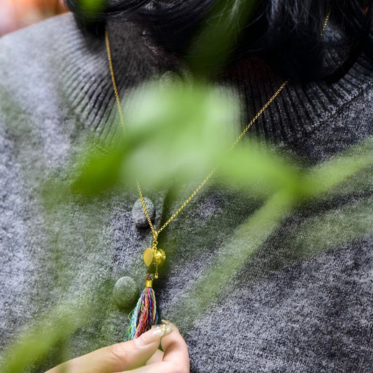 Tibetan Buddhist Jewelry Culture: A handmade sterling silver Damaru drum pendant accessory for mala beads, showcasing sacred Buddhist jewelry art.