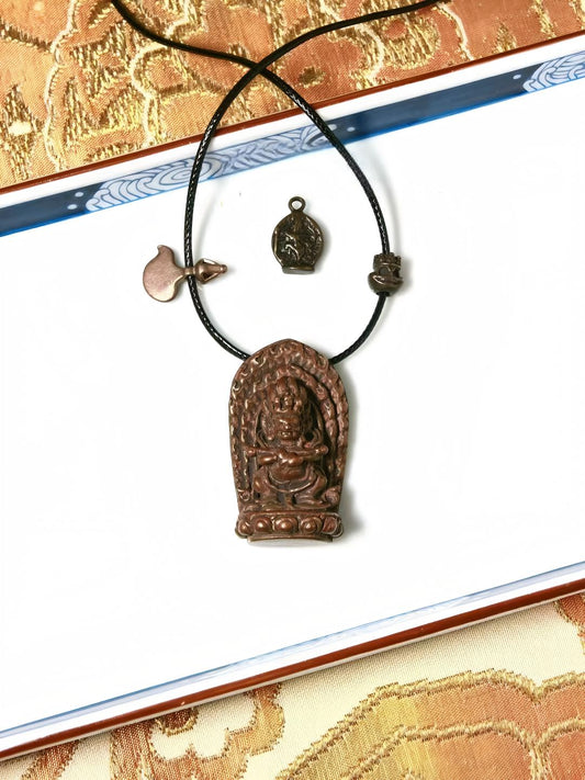 Bronze Mahakala figure holding a red staff, handcrafted and hand-painted, representing Tibetan Buddhist Jewelry Culture, with rich spiritual meaning and artistic craftsmanship