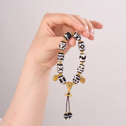 Handcrafted Tibetan Buddhist black and white multi-gem agate bead bracelet, featuring lucky amulet Dzi beads for spiritual protection and positive energy.