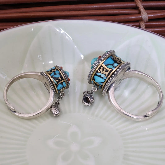 Intricate hand-carved blue mantra ring featuring Om Mani Padme Hum, showcasing artisan jewelry art from Tibetan Buddhist Jewelry Culture.