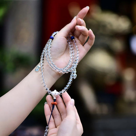 Tibetan Buddhist Jewelry Culture: A handmade natural clear quartz 108 mala beads necklace, showcasing sacred Buddhist jewelry art and purity.
