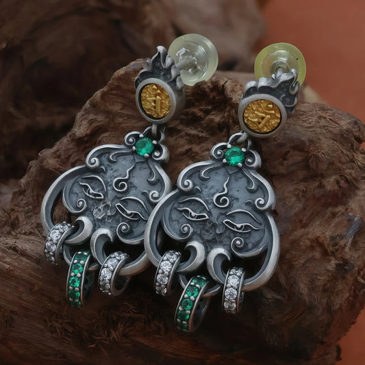 Hand-painted silver Manjushri Buddha Eye seed word dangle earrings, reflecting Tibetan Buddhist jewelry culture and exquisite jewelry art, ideal for spiritual wear or gifting.