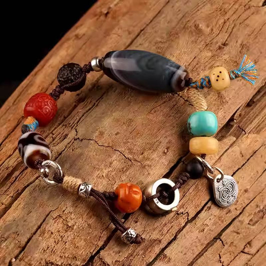 Handcrafted Tibetan agate bracelet with Black Jambhala beads, vintage style, spiritual accessory for protection, good fortune, and personal expression.