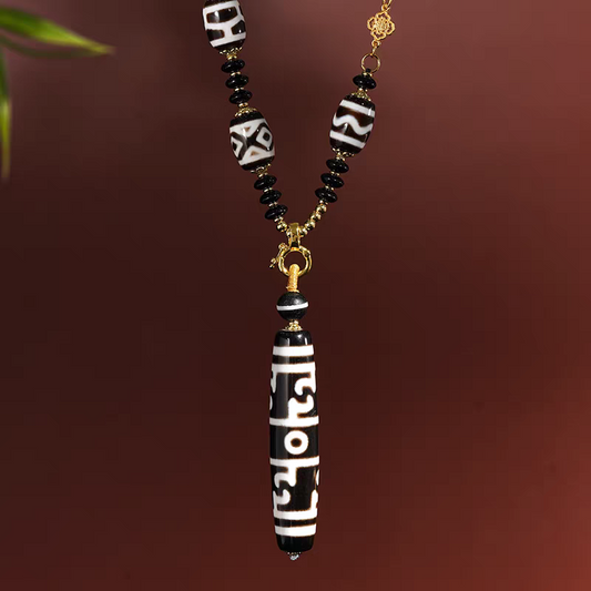 Tibetan Buddhist Jewelry Culture pure black and white Lotus Guru Dzi necklace with ritual implements totems. A masterpiece of jewelry art in natural agate.