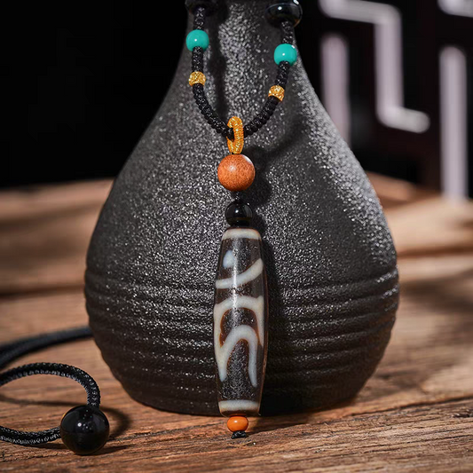 Tibetan Buddhist Jewelry Culture natural agate necklace featuring a sacred Dzi bead. A high-vibrational piece of jewelry art.