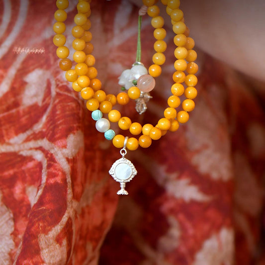 Tibetan Buddhist Jewelry Culture: A handmade sterling silver Eight Offering Goddess accessory for mala beads, showcasing sacred Buddhist jewelry art.