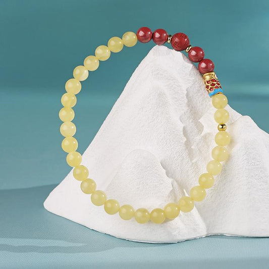 Tibetan Buddhist Jewelry Art: Hand-Painted Amber and Cinnabar Koi Bracelet, symbolizing luck and prosperity in Tibetan Buddhist tradition