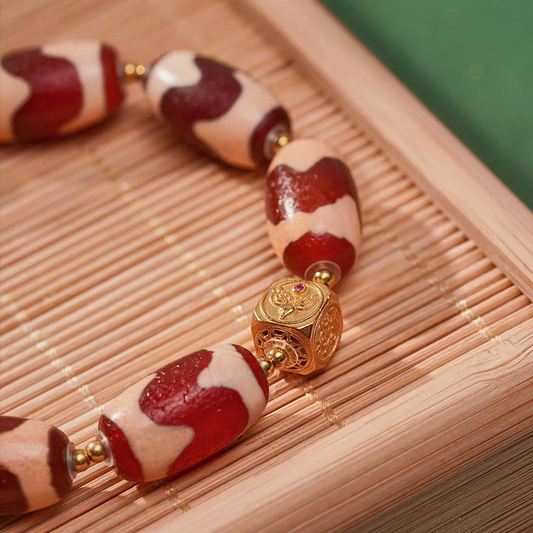 Tibetan Buddhist handmade red mutton tiger fang bead bracelet, a unisex lucky charm promoting wealth, spiritual balance, and personal energy.