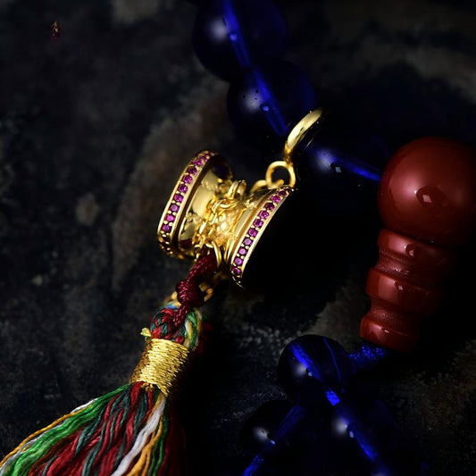 Tibetan Buddhist Jewelry Culture: Sacred silver accessory featuring the Damaru drum, a unique fusion of ritual functionality and Buddhist art.
