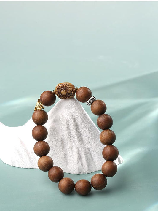 Full view of the Golden Sandalwood, Bone, and 925 Silver Bracelet. Features natural golden sandalwood beads alternating with pure bone beads, accented by 925 silver spacers, showcasing the material beauty and exquisite craftsmanship of Tibetan Buddhist jewelry.