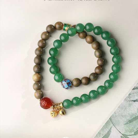 Distant Haze green sandalwood and agate bracelet in Tibetan Buddhist jewelry art, featuring hand-painted mountain mist motifs for grounding meditation.