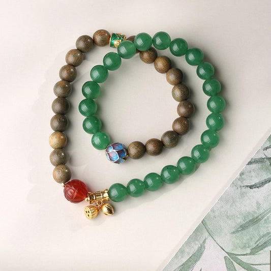 Hand-painted green sandalwood and agate natural energy bracelet in Tibetan Buddhist jewelry culture, promoting connection with nature's balance.