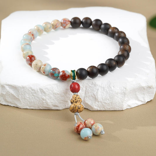 Lush Field Shoushan Stone and Agarwood bracelet in Tibetan Buddhist jewelry art, featuring hand-painted longevity symbols and spiritual motifs for wisdom and protection.
