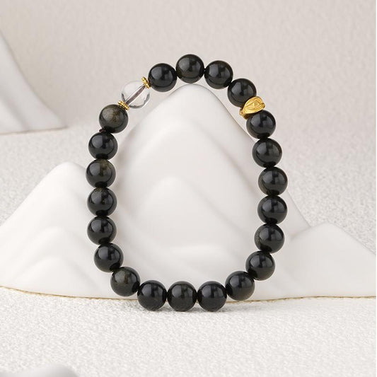 Night Brilliance Golden Obsidian bracelet with crystal accents, featuring Tibetan Buddhist jewelry art for wealth and protection.