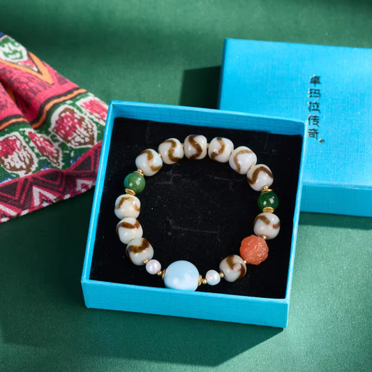 Tibetan Buddhist sacrificial implements culture Larimar and Tiger Tooth Darlok Dzi bead bracelet. Handcrafted with natural blue Larimar as a piece of Buddhist sacrificial items art.