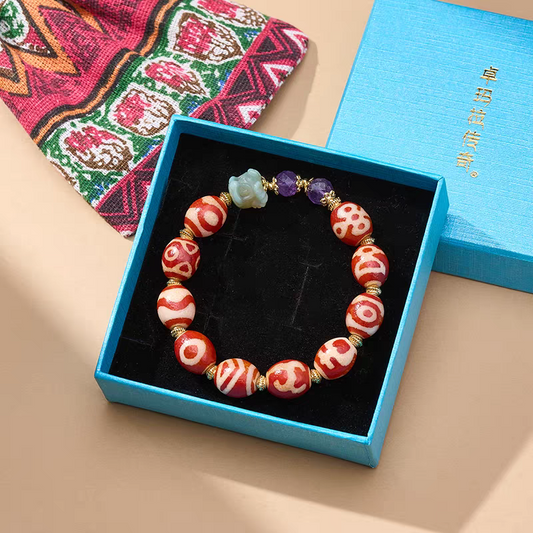 Tibetan Buddhist sacrificial implements culture red agate Darlok multi-totem Dzi bead bracelet. Handcrafted natural agate representing Buddhist sacrificial items art.