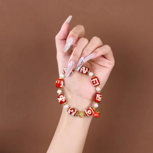 Authentic barrel-shaped red meat agate Dzi bead bracelet, showcasing Buddhist sacrificial items art and Tibetan Buddhist sacrificial implements culture. Purely handmade.