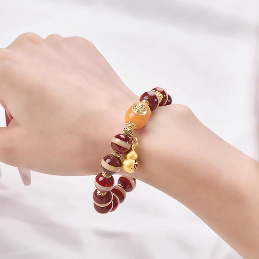 Authentic red meat Medicine Buddha bead Dzi bracelet, showcasing Buddhist sacrificial items art and healing energy within Tibetan Buddhist sacrificial implements culture.