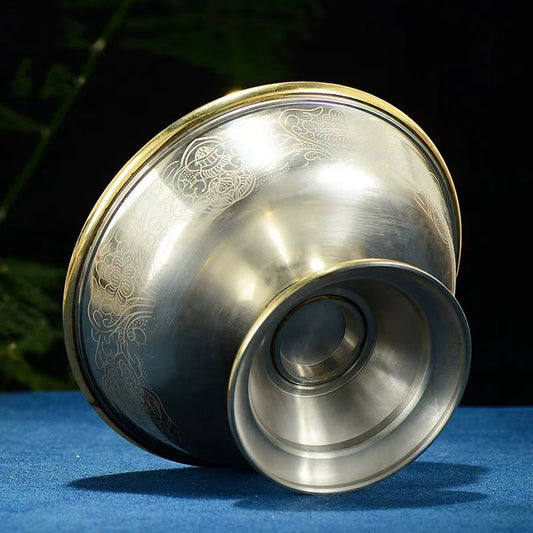Tibetan Buddhist sacrificial implements culture: Close-up of an Ashtamangala offering cup showcasing exquisite Buddhist sacrificial items art and traditional Tibetan craftsmanship.