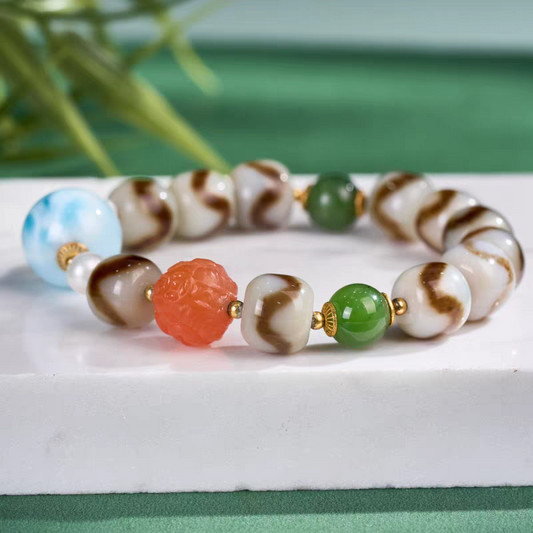 Exquisite Larimar and Tiger Tooth Darlok Dzi jewelry, a spiritual artifact rooted in Tibetan Buddhist sacrificial implements culture for courage and peace.