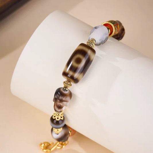 Handcrafted Panda Dzi bracelet with Citipati skull motif, representing power and protection in Buddhist sacrificial items art.