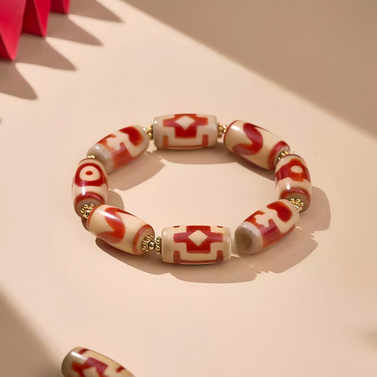 Handcrafted small red meat Dzi bracelet with bucket beads, representing a blend of Buddhist sacrificial items art and ancient traditions.