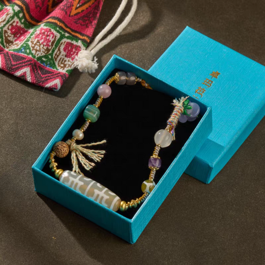 Spiritual natural agate jewelry art inspired by Tibetan Buddhist sacrificial implements culture, featuring the auspicious white urna Lotus Guru Dzi.