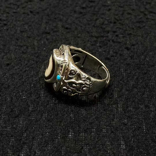 A masterpiece of Tibetan Buddhist jewelry art, this sterling silver Amitabha Buddha ring showcases exquisite inlaid craftsmanship symbolizing infinite compassion and wisdom.