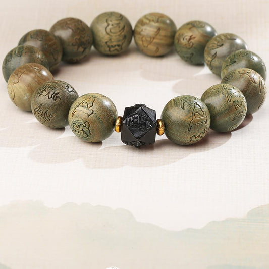Handmade Tibetan Buddhist mala bracelet crafted from natural green sandalwood and protective obsidian beads. This sacred jewelry art embodies traditional Tibetan craftsmanship for meditation and spiritual practice, offering calming energy and negative energy protection.
