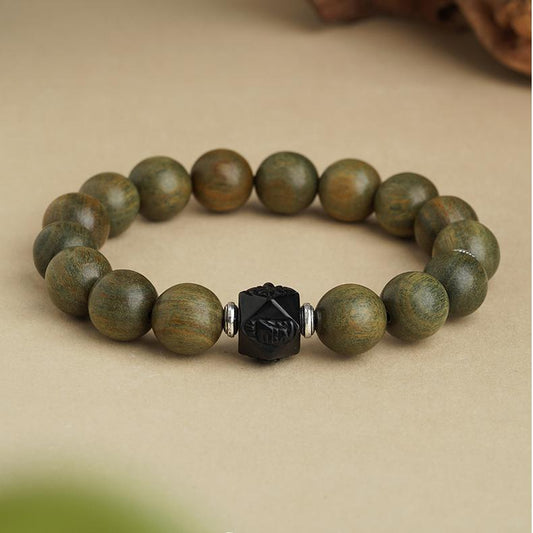 Zen Sandalwood Spiritual Bracelet showcasing traditional obsidian and copper ornaments. This Tibetan Buddhist jewelry art embodies peaceful energy for daily practice.