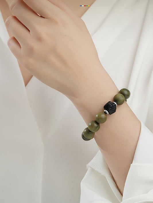 Harmony Sandalwood Mala Strand handcrafted with black obsidian and copper components. This Tibetan Buddhist jewelry culture promotes energetic balance.