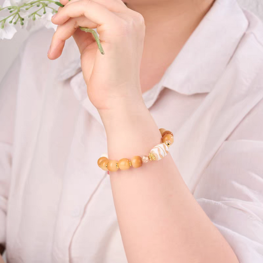 Handcrafted Tibetan Buddhist Double Tiger Tooth Dzi bead bracelet, combining spiritual protection, positive energy, and traditional jewelry art.