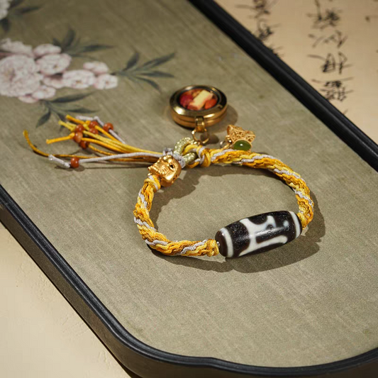 Handcrafted Tibetan Buddhist Ten-Aspects bracelet featuring Yellow Jambhala, Green Tara, and Manjushri, combining spiritual protection, wealth, and traditional jewelry art.