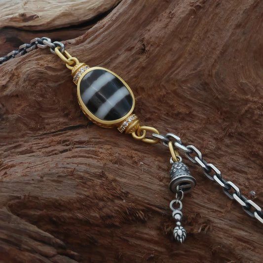 Carved silver Treasure Mouse necklace in Tibetan Buddhist jewelry culture, wearable jewelry art for prosperity and good fortune.