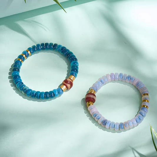 Handcrafted Tibetan Buddhist red coral tiger tooth Dzi bead bracelet, combining spiritual protection, good fortune, and traditional jewelry art.