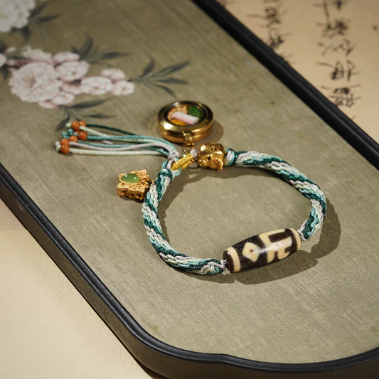 Handmade Tibetan Dzi bracelet with Yellow Jambhala and Green Tara, crafted in authentic Tibetan Buddhist jewelry culture and artisan jewelry art.