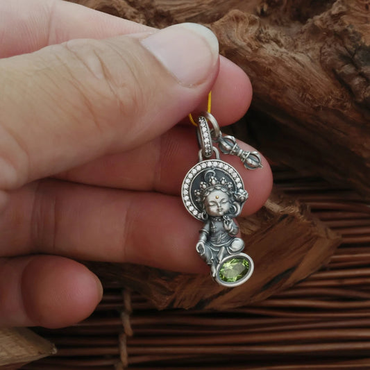 Hand-painted silver Yellow Jambhala and Green Tara pendant inspired by Tibetan Buddhist jewelry culture, symbolizing wealth and compassion.