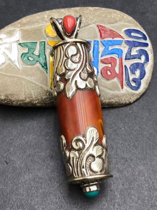 Handcrafted Warring States red agate pendant, featuring intricate Tibetan Buddhist design. Symbolizes protection, spiritual growth, and transformation.