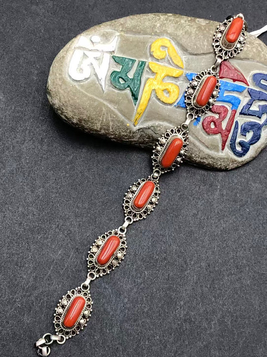 Handmade red bracelet, embodying Tibetan Buddhist jewelry culture with vibrant color and intricate craftsmanship, perfect for adding elegance and spiritual symbolism.