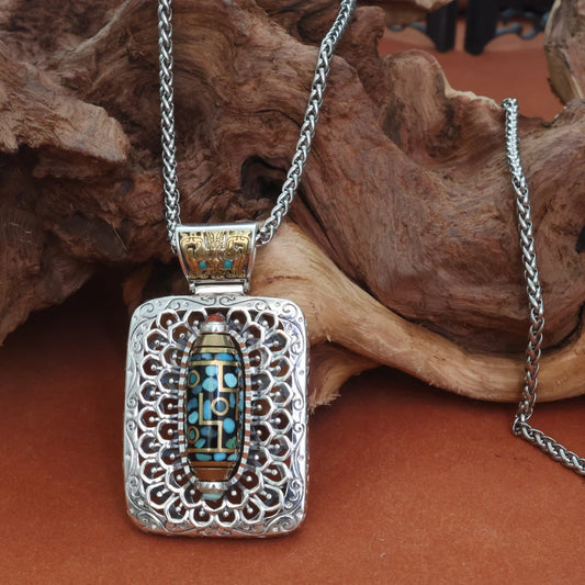 Handcrafted silver nine-eye Taotie square pendant inspired by Tibetan Buddhist jewelry culture, symbolizing protection and fortune.