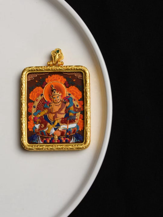 Tibetan Yellow Jambhala thangka pendant crafted as jewelry art, symbolizing fortune, generosity, and positive energy.