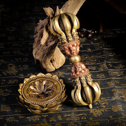 A 21cm handcrafted Nine-Pronged Vajra with base, made from brass and copper, embodying the wisdom and protection of Tibetan Buddhism. Perfect for altars and spiritual spaces.