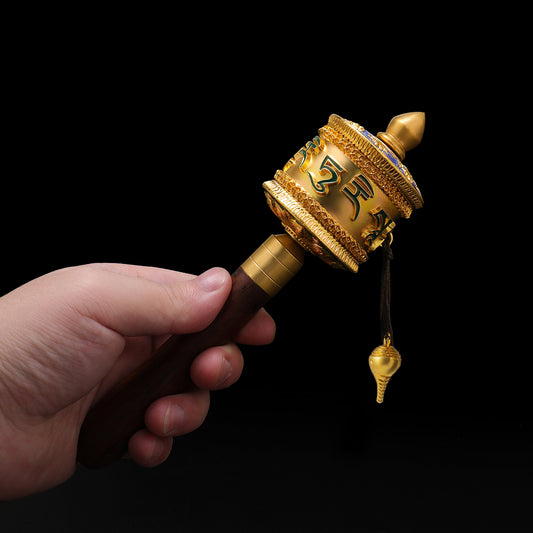 Handcrafted Green Tara hand rattle made from brass and enamel. Symbolizing compassion and protection, ideal for Tibetan Buddhist rituals and altars.