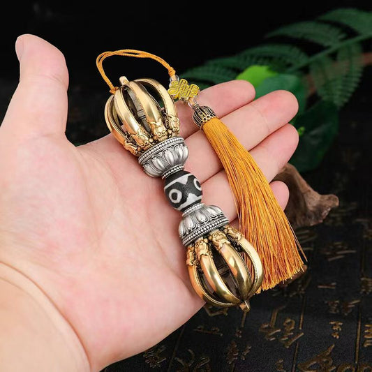 This handcrafted brass Phurba, featuring nine prongs, represents divine protection and wisdom. A unique Tibetan Buddhist ritual implement that doubles as a stunning art piece for any space.